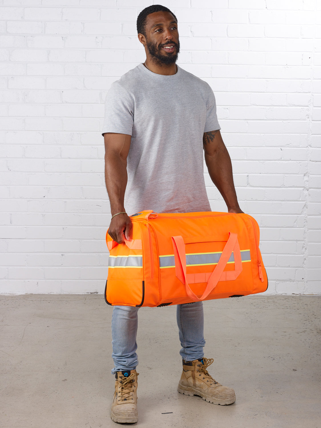 Caribee Bunker Hi Vis Gear Bag - Orange - with model 3
