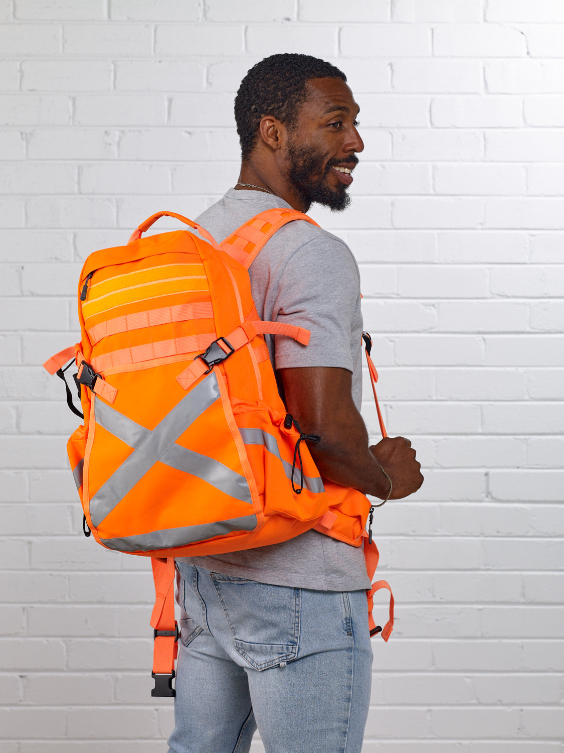 Worker wearing Caribee Mineral King 32L hi-vis safety backpack